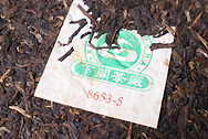 Xiaguan Shuangjie Iron Cake PuerFT8653 photo:Puerh tea leaf